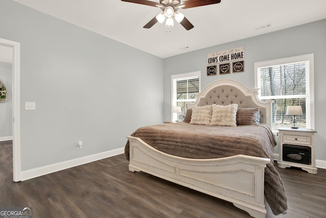 bedroom featuring dark wood-type flooring, visible vents, ceiling fan, and baseboards