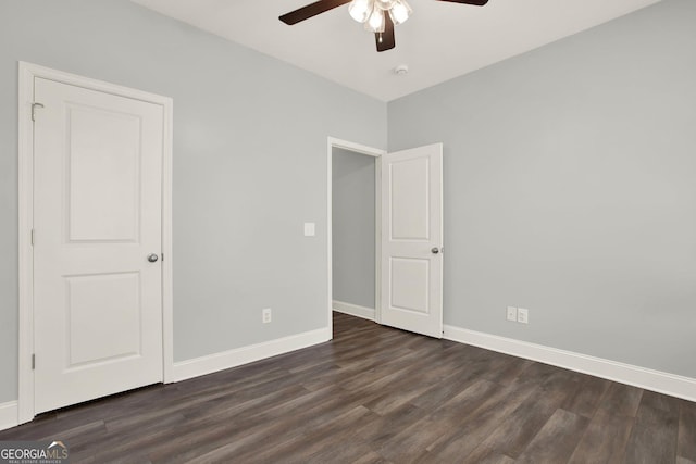 unfurnished bedroom with ceiling fan, baseboards, and dark wood finished floors