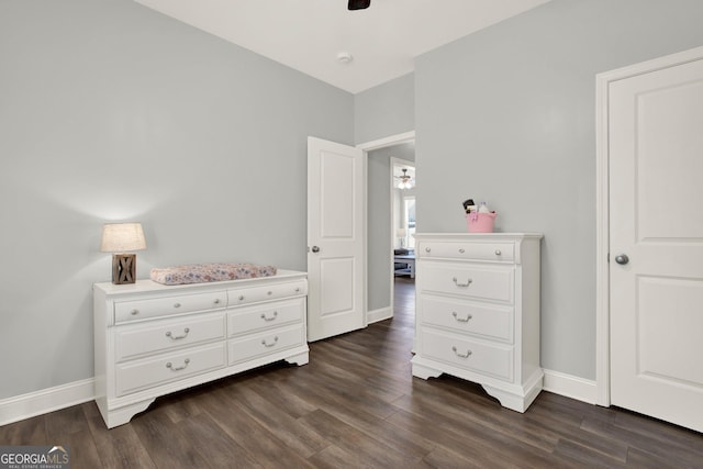 bedroom with dark wood-style floors, ceiling fan, and baseboards