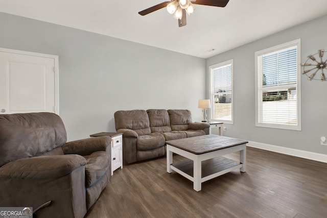 living room featuring dark wood-style floors, ceiling fan, and baseboards