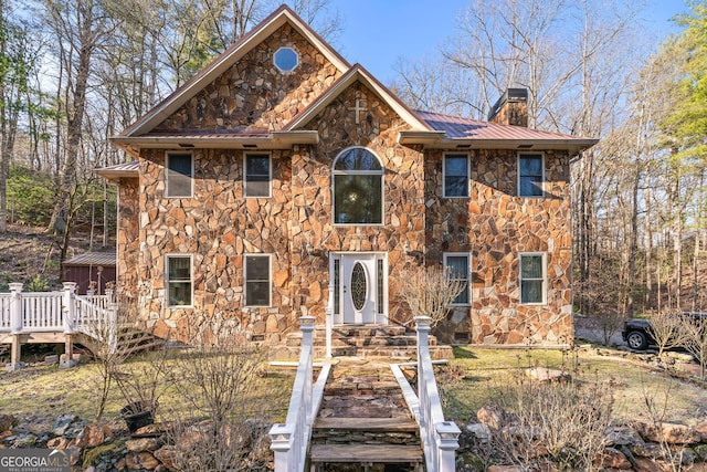 3360 Turniptown Rd, Ellijay, GA 30536 - view of front facade with stone siding, a chimney, metal roof, and a deck