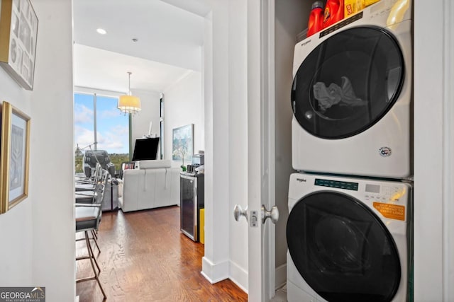 3630 Peachtree Rd NE Unit 1809, Atlanta, GA 30326 - laundry room featuring stacked washer / drying machine and wood finished floors
