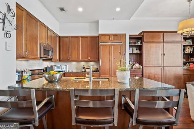 3630 Peachtree Rd NE Unit 1809, Atlanta, GA 30326 - kitchen featuring open shelves, paneled built in fridge, stainless steel microwave, brown cabinets, and tasteful backsplash