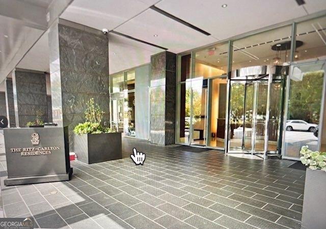 3630 Peachtree Rd NE Unit 1809, Atlanta, GA 30326 - common area with a wall of windows and a surveillance system