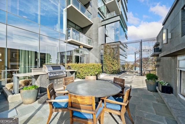 3630 Peachtree Rd NE Unit 1809, Atlanta, GA 30326 - view of patio with exterior kitchen and outdoor dining space