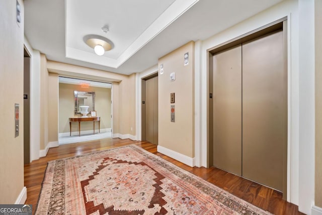3630 Peachtree Rd NE Unit 1809, Atlanta, GA 30326 - corridor with elevator, wood finished floors, and a tray ceiling