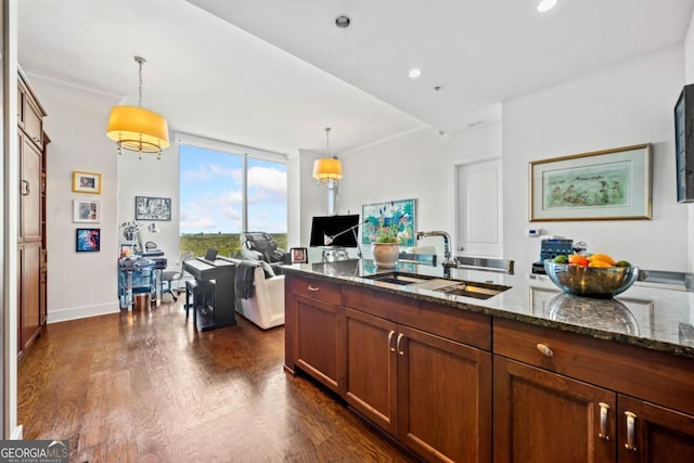3630 Peachtree Rd NE Unit 1809, Atlanta, GA 30326 - kitchen with dark wood-style floors, dark stone counters, a desk, hanging light fixtures, and brown cabinets