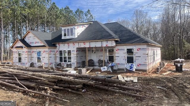 unfinished property with roof with shingles