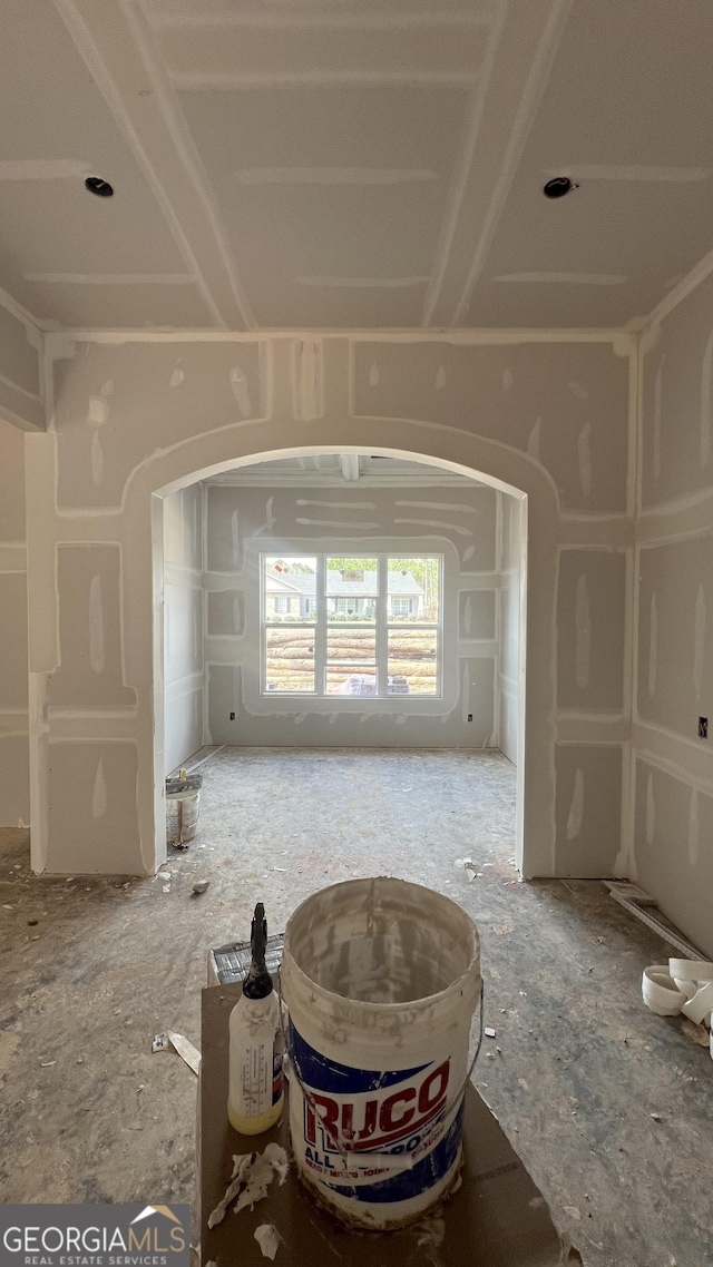 empty room featuring arched walkways