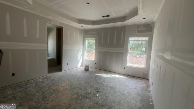 unfurnished bedroom featuring visible vents and a raised ceiling