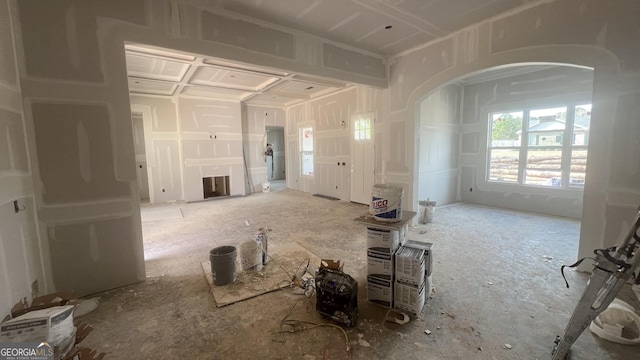 interior space with arched walkways and a fireplace