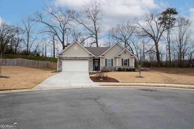 view of front of house featuring a garage, stone siding, fence, and concrete driveway