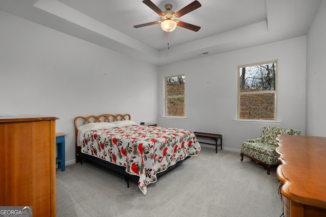 bedroom with carpet, a raised ceiling, visible vents, and baseboards