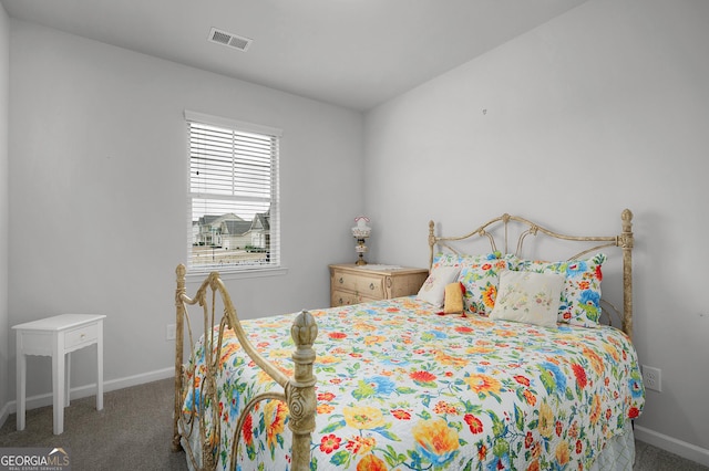 carpeted bedroom featuring visible vents and baseboards