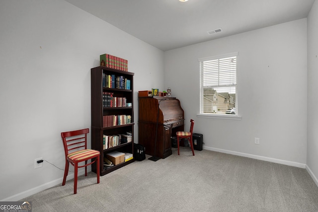 sitting room with baseboards, visible vents, and light colored carpet