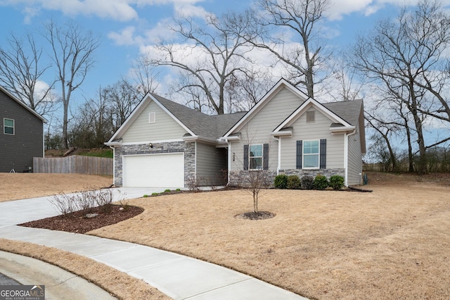 craftsman-style home with an attached garage, fence, stone siding, concrete driveway, and roof with shingles