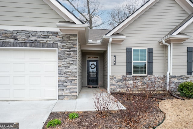 view of exterior entry with a garage and stone siding