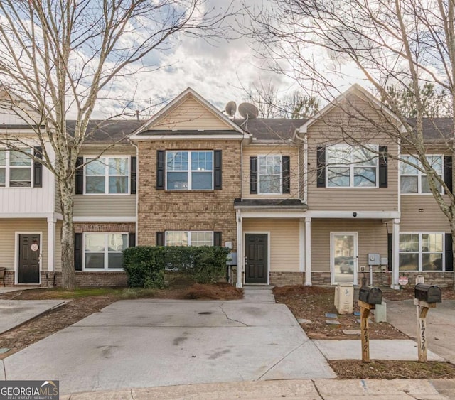 townhome / multi-family property featuring brick siding