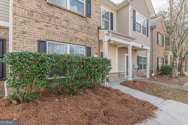 exterior space featuring brick siding