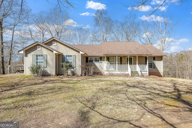 single story home with roof with shingles, a porch, and a front yard