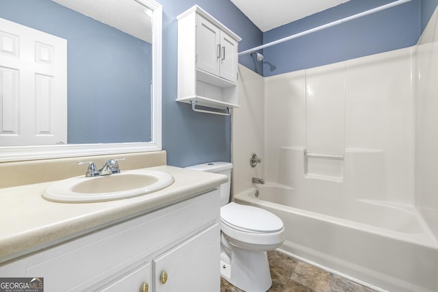 full bath featuring tub / shower combination, a textured ceiling, toilet, and vanity