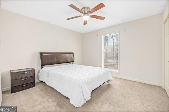 bedroom with baseboards, a ceiling fan, and light colored carpet