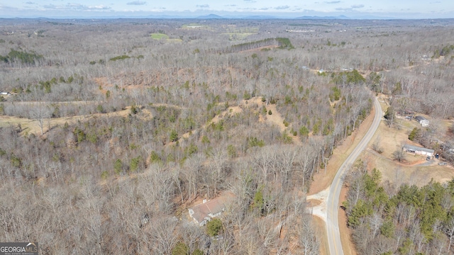 birds eye view of property with a view of trees