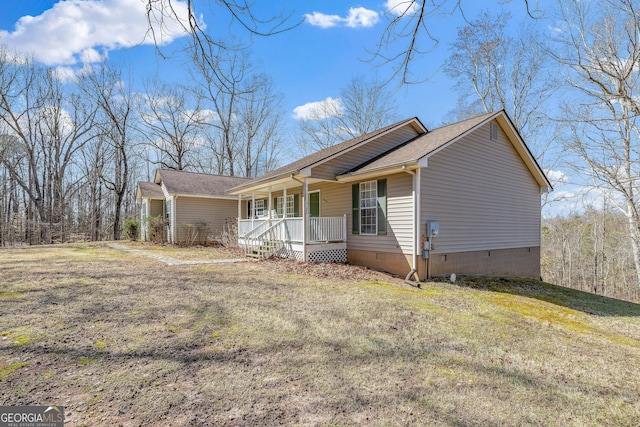 view of side of property featuring a yard, a porch, crawl space, and a shingled roof