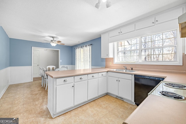 kitchen featuring light countertops, white cabinetry, a sink, dishwasher, and a peninsula