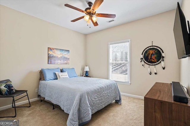 bedroom with a ceiling fan, visible vents, light carpet, and baseboards