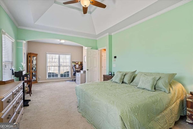 bedroom featuring arched walkways, a tray ceiling, crown molding, light colored carpet, and ceiling fan