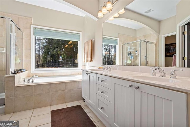 full bath featuring a stall shower, tile patterned flooring, visible vents, and a sink