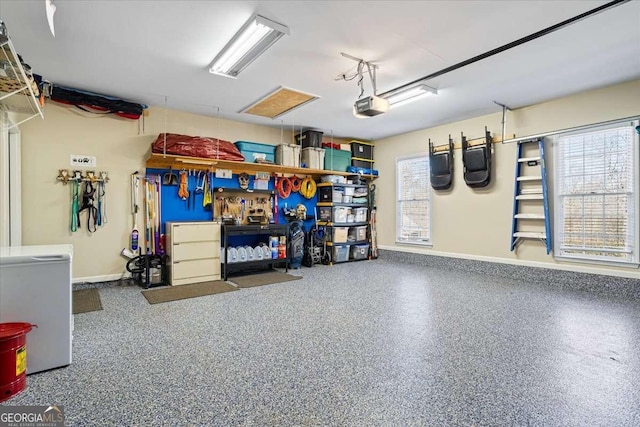 garage with a garage door opener, baseboards, and fridge