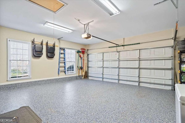 garage with baseboards and a garage door opener