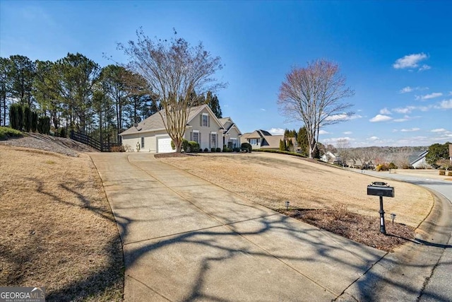 view of street featuring concrete driveway and a residential view