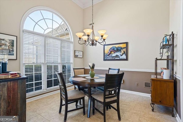 dining room featuring light tile patterned floors, baseboards, visible vents, and a notable chandelier