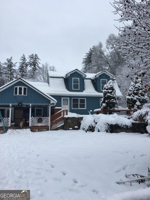 view of snow covered back of property