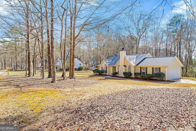 view of front of property with a garage and a chimney