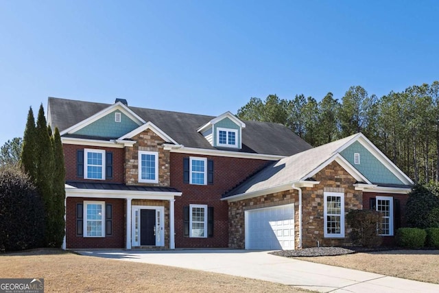 view of front of house with a garage, stone siding, brick siding, and driveway