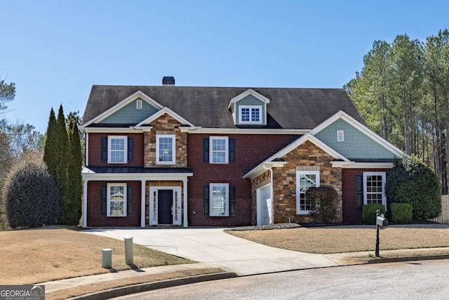 view of front facade with concrete driveway, brick siding, a chimney, and stone siding