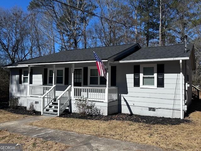 single story home with a shingled roof, crawl space, and covered porch