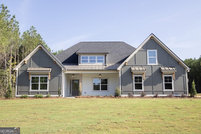 view of front of home featuring metal roof, a front lawn, and a standing seam roof