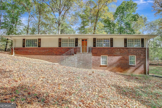 ranch-style house featuring brick siding