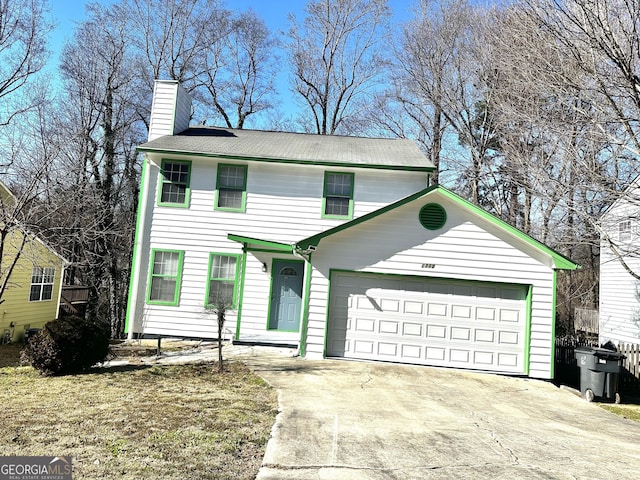 view of front of house with driveway, a chimney, and an attached garage