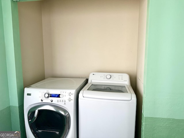 clothes washing area with laundry area and separate washer and dryer