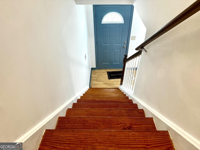 staircase featuring wood finished floors