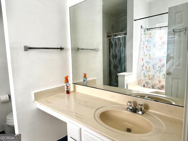 bathroom featuring vanity and toilet