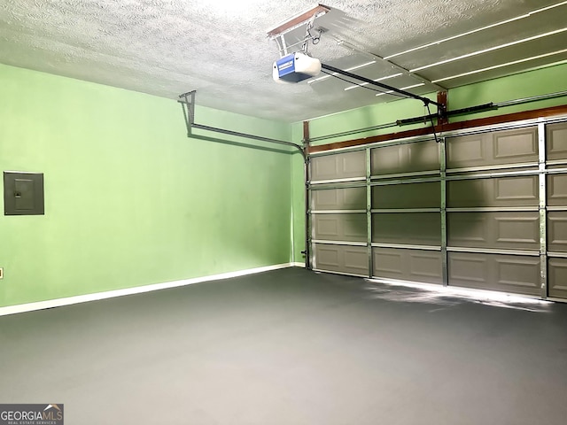 garage featuring a garage door opener, electric panel, and baseboards