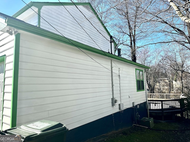 view of home's exterior featuring central AC unit and a wooden deck