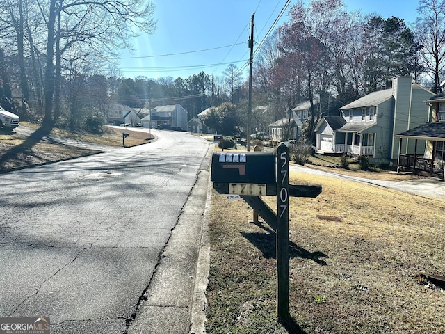 view of street featuring a residential view and curbs